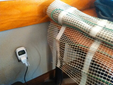 Pictured here is standard 110 volt plug-in and thermostat which powers the folded up carpet heater runner on the right.